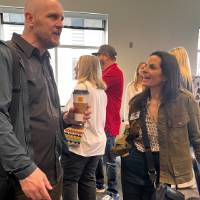 Two event attendees chatting with each other at event